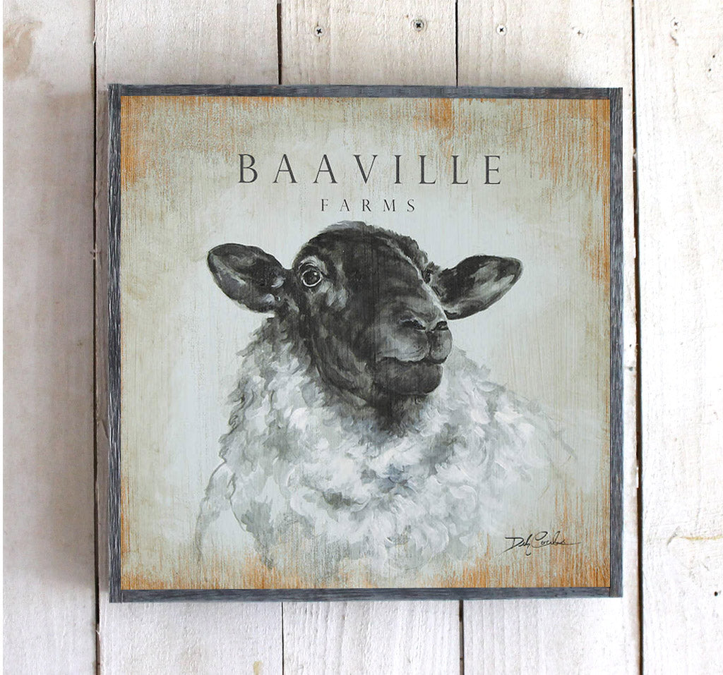 Baaville Farms, farmhouse sheep in white grey and black, background is sort of a robin's egg blue with lots of distress around the edges, printed on wood so the warm grainy feel comes thru, framed in grey barnwood 1 1/2 inches deep. L:ots of shabby chic, french farmhouse feel.