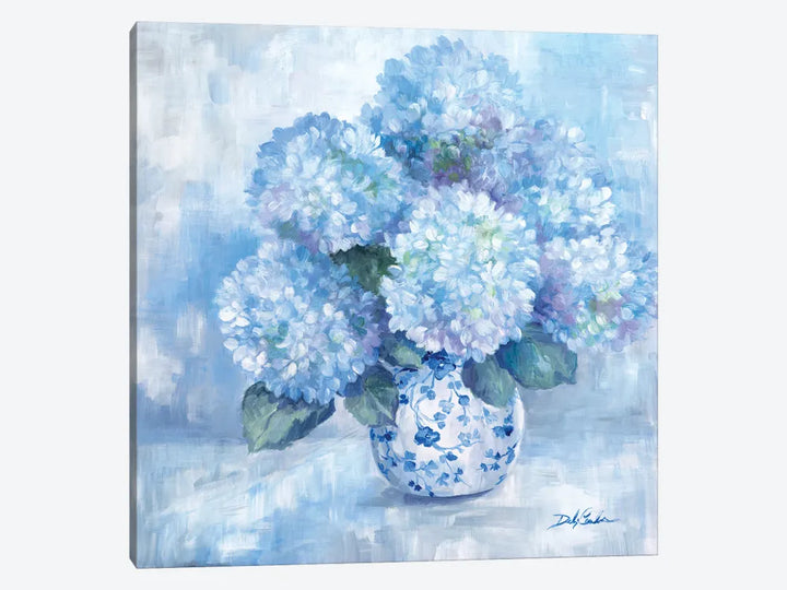 A white and blue vase full of blue hydrangeas, with greenery. Purples intertwine as do whites. Background in neutral shades of greys blues. Painting on canvas by Debi Coules