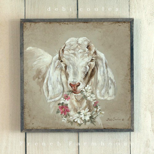A beautiful long eared Farmhouse Goat in tans and white on a tan background. He is holding a floral wreath filled withe wild roses in pink and white. Printed on wood, framed in wood. This is part of the farmhouse collection at Debi Coules Art