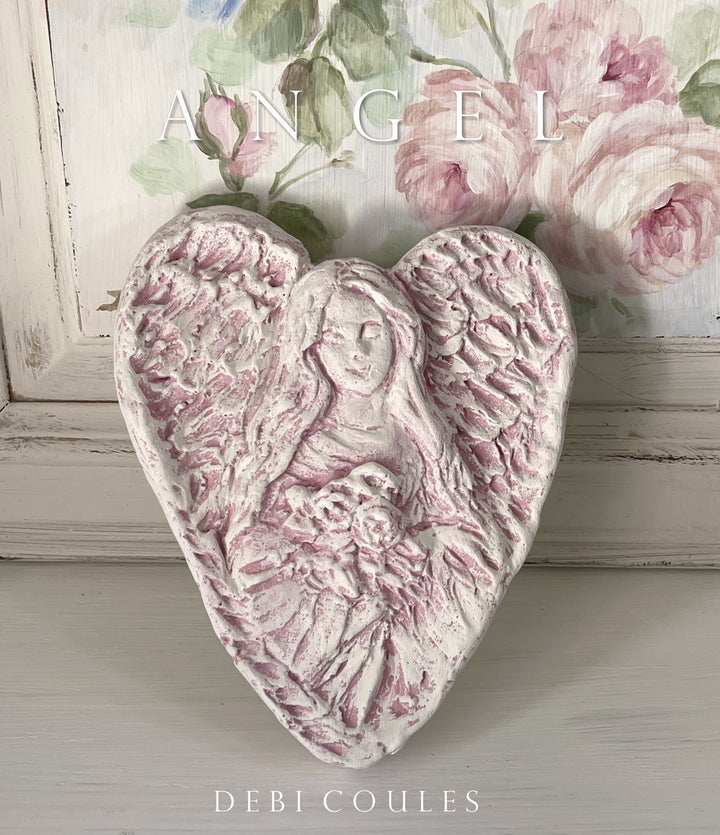 Hand carved pink angel heart by debi coules, white with pink accents. material: plaster paris reproduction