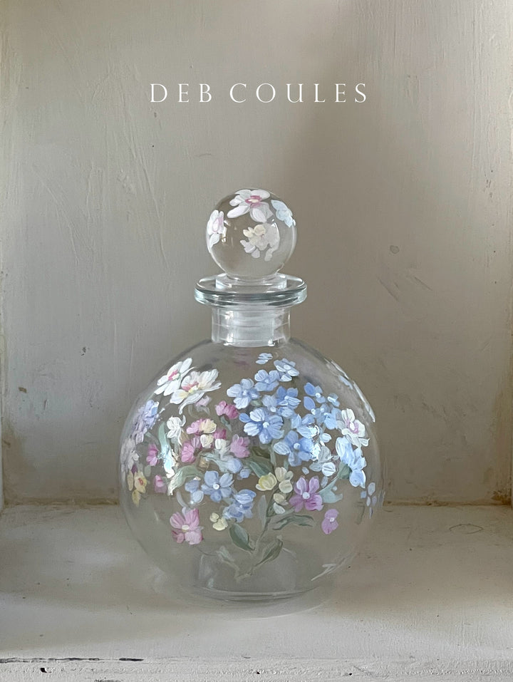 Charming hand painted glass perfume with pink, blue, yellow and white wildflowers. round stopper makes it complete. Original Vintage Shabby Chic look by Debi Coules
