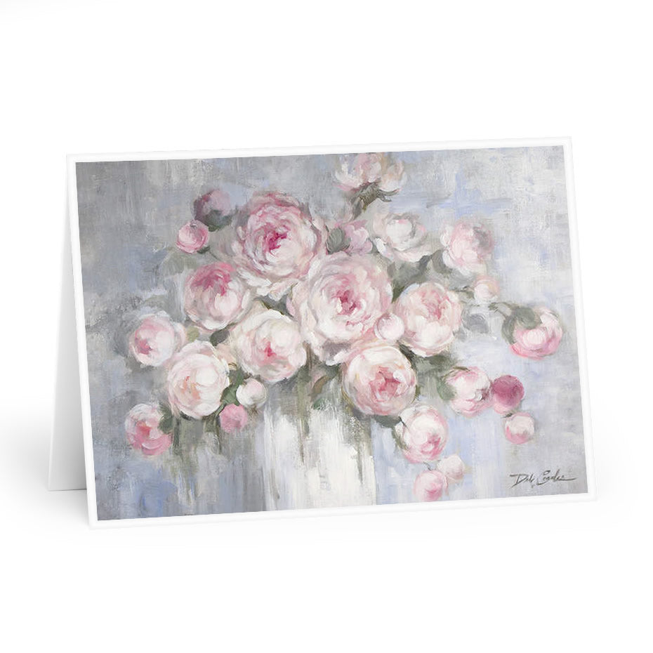 Pink and white cabbage roses fill a white vase. Blueish grey backdrop. Original by Debi Coules