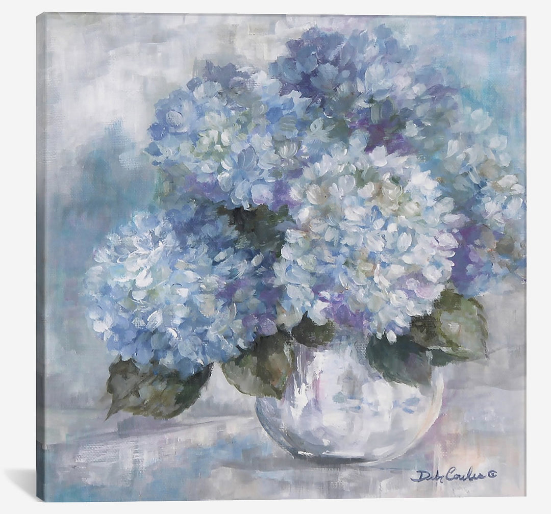 A white vase full of blue hydrangeas, with greenery. Purples intertwine as do whites. Background in neutral shades of greys blues. Painting on canvas by Debi Coules