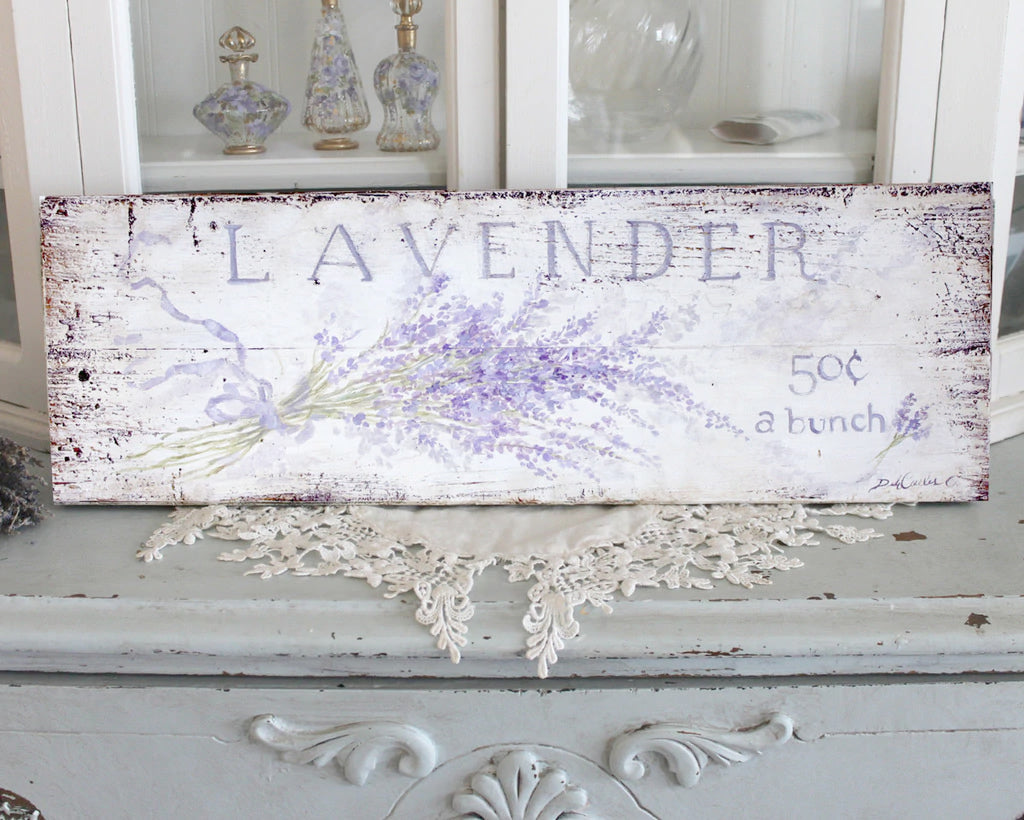 Off white background with lots of distressing. A bouquet of Lavender create a wonderful backdrop for the slogan "Lavender 50 cents a bunch" Perfect for your shabby chic, or french chic home